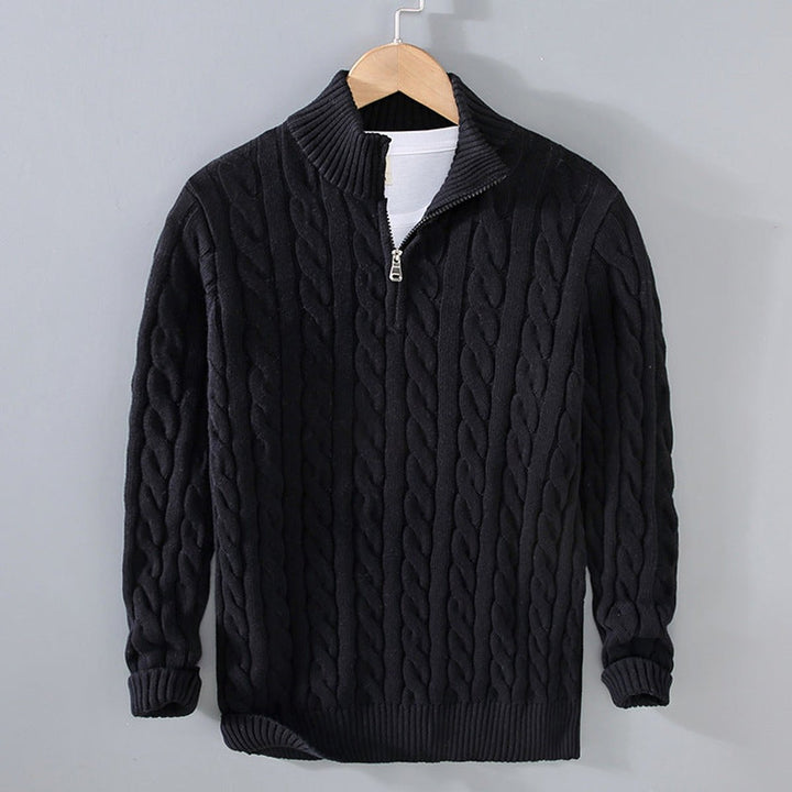 Sebastian cable knit quarter zip sweater in black, front view on hanger